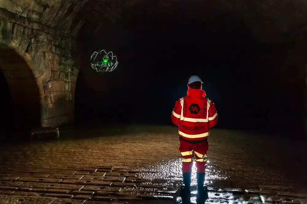 Sky Scan Surveys | Measured Building Survey Cost UK (2025): Your Complete Pricing & ROI Guide with 3D Laser Scanning Expertise : Image of a surveyor working in a confined space or an area with difficult access within a building, illustrating site challenges