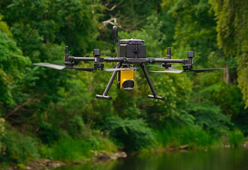 Sky Scan Surveys | LiDAR Drone Survey Services in the UK: Precision Mapping Experts at Sky Scan Surveys Advanced LiDAR drone conducting a topographical survey over dense vegetation in the UK.
