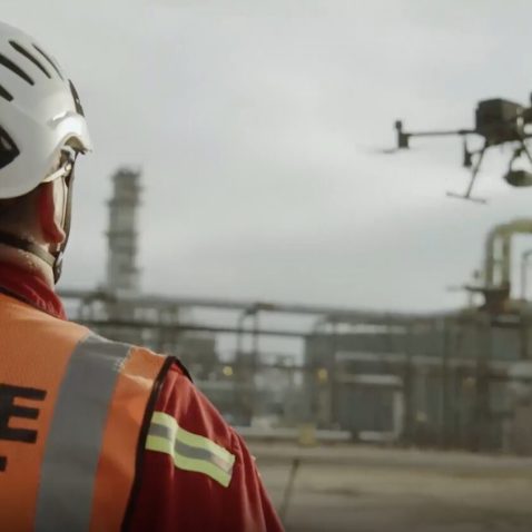 Man carrying out drone roof inspection